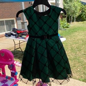 A green and black Dress it’s glittery.my younger sister only wore it once